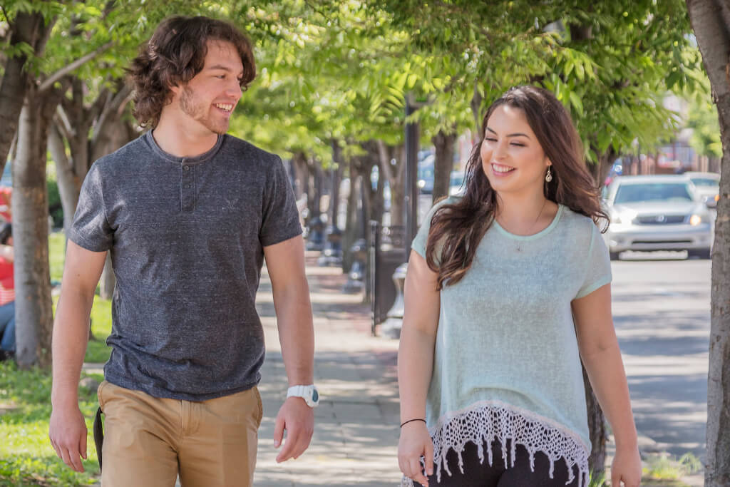 guy and girl walking on campus smiling