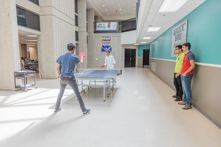 students playing ping pong in jefferson campus building