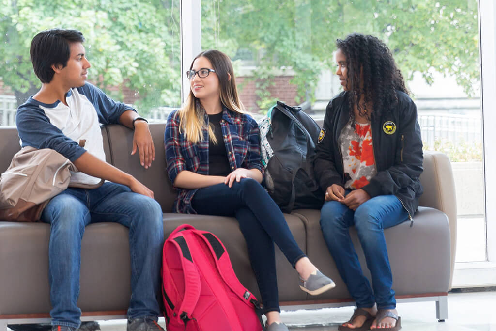 male and female students in campus lounge