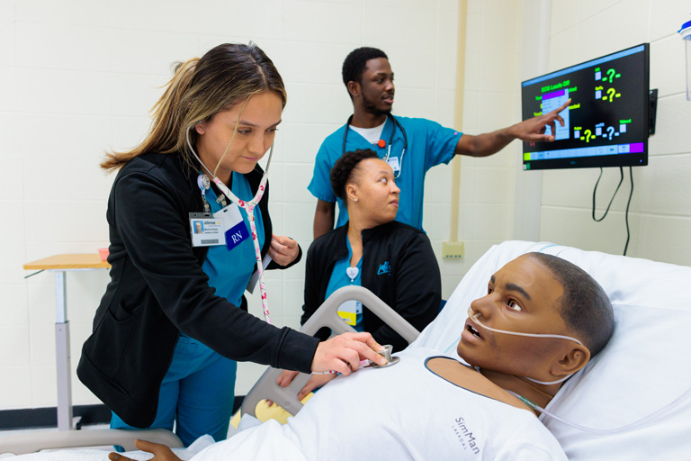 student practicing on a mannequin