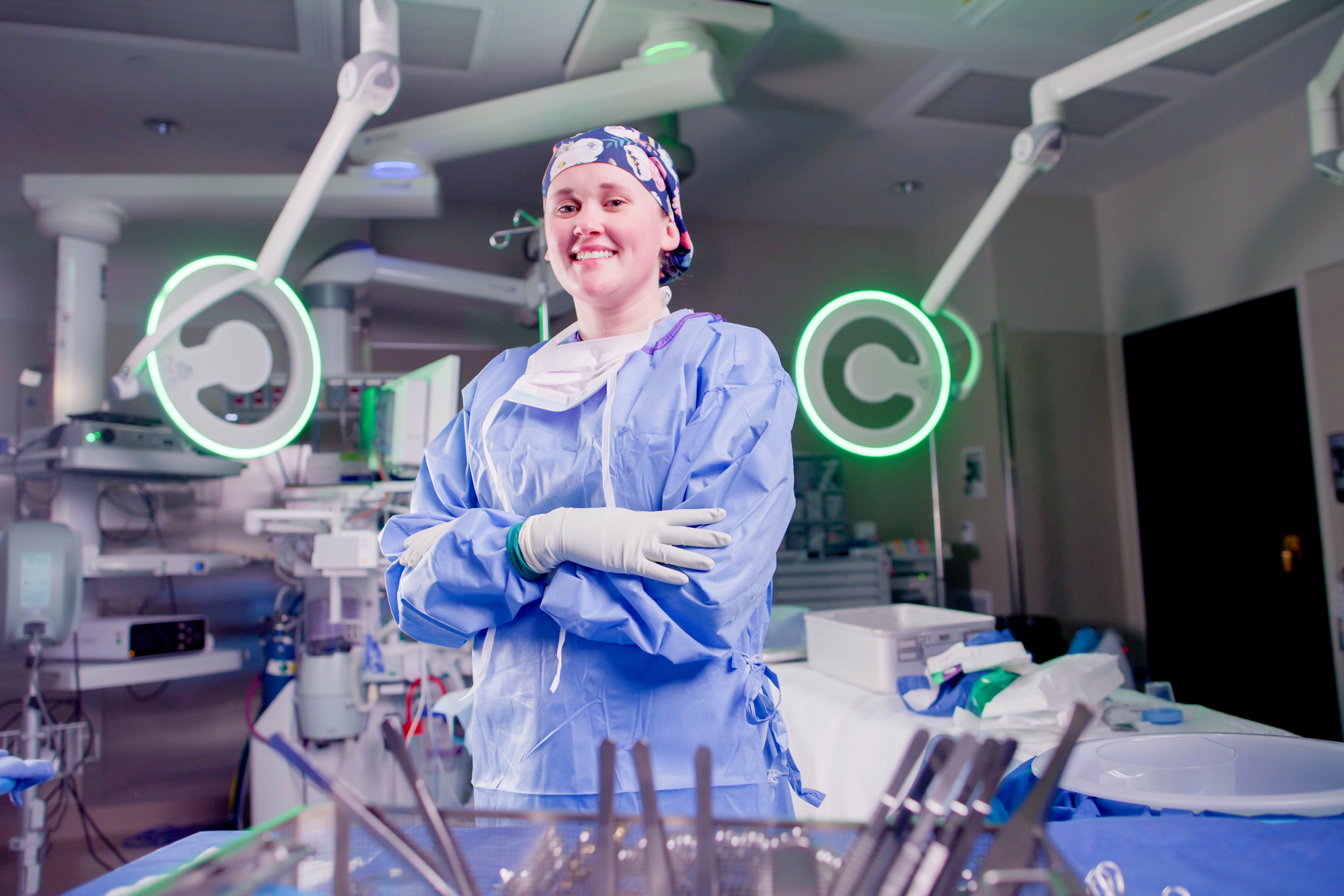 surgical technologist smiling at the camera in an operating room